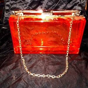Clear red acrylic clutch